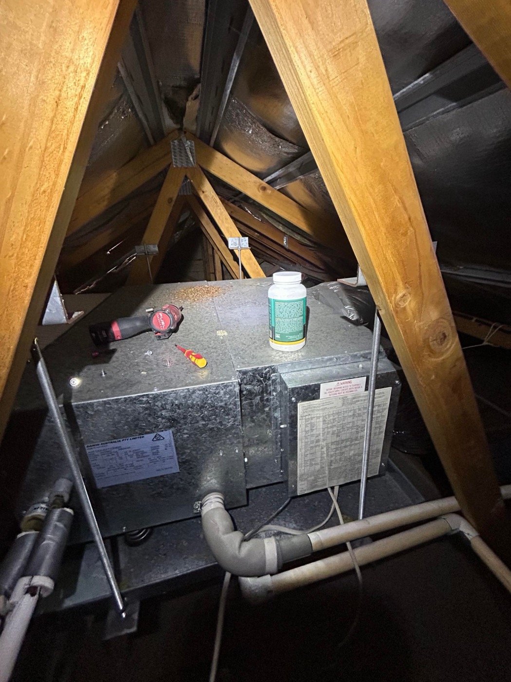 Ducted air conditioning fan coil being cleaned in a Perth roof space