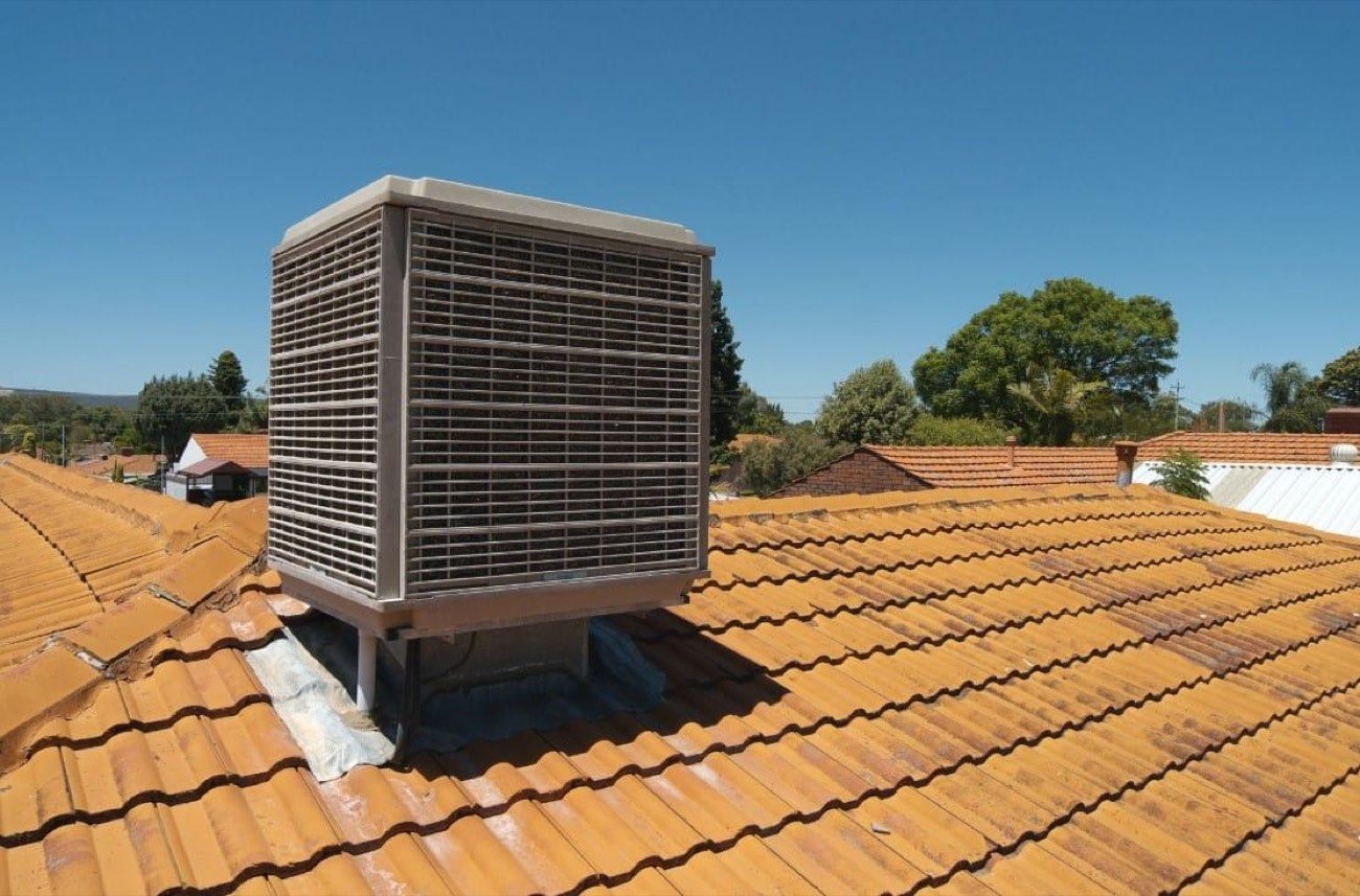 Evaporative air conditioner on a tiled roof in Perth